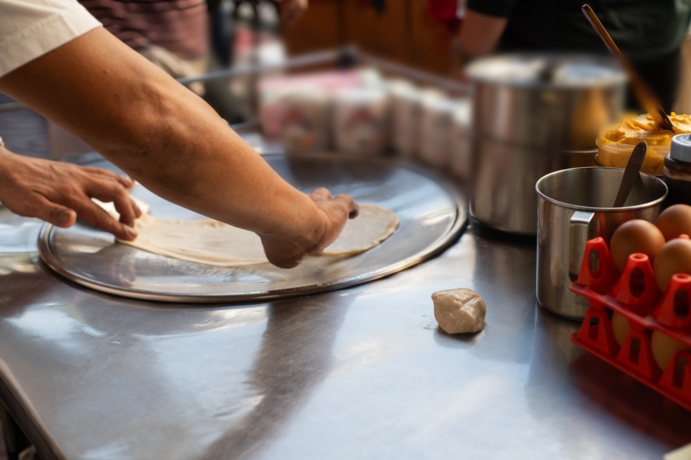 A street food vendor in Patong making roti pancakes 