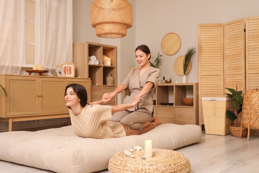 A woman receives a traditional type of Thai massage. 