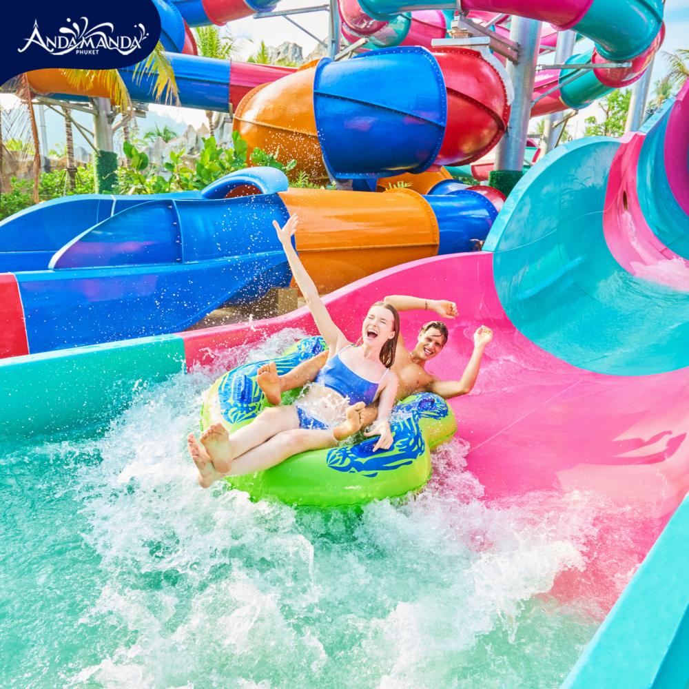 A couple going down a slide at Andamanda Water Park